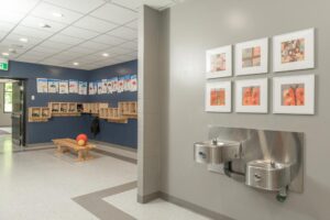 Hallway with fountains and coat racks for accessibility