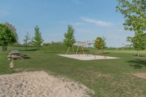 School playground with swingsets and picnic tables